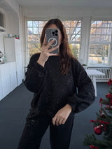 Oversized Oberteil mit Glitzer und Ballonärmeln, kürzer vorne, länger hinten – Gr. 36-42 schwarz